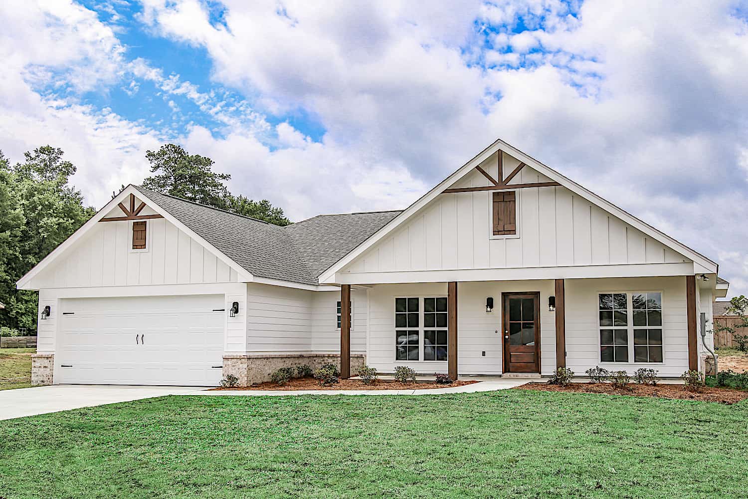Main exterior photo of Plan #142-1271: A charming Ranch-style home with a covered front porch, forward-facing gables, and natural wood timber trim.